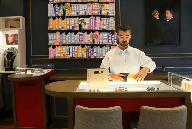 Sales manager in showroom preparing an order in a jewellery box